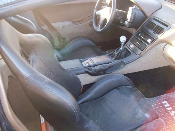 I replaced the shift boot and re-upolstered the center console in black leather. Also, installed new leather seats, and bought aluminum custom nismo floor mats. Here is what it looked like before I ripped out the nasty tan upolstery, and re-upolstered with aztec red custom vinyl.